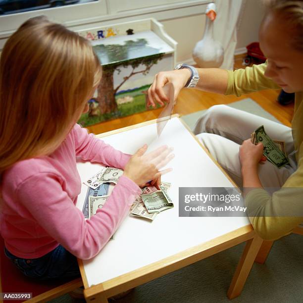 young girls counting money - family dollar stock pictures, royalty-free photos & images