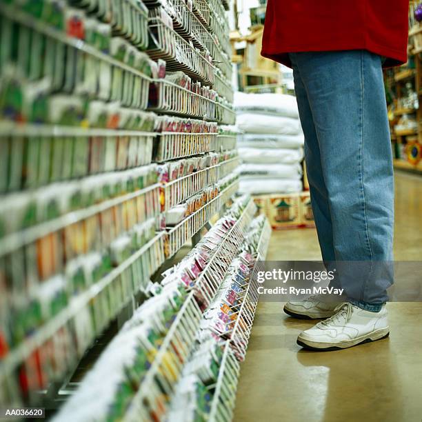 man shopping for seeds in a garden center - center position stockfoto's en -beelden