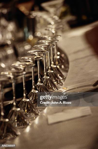 row of martini glasses on bar - upside down perspective stock pictures, royalty-free photos & images
