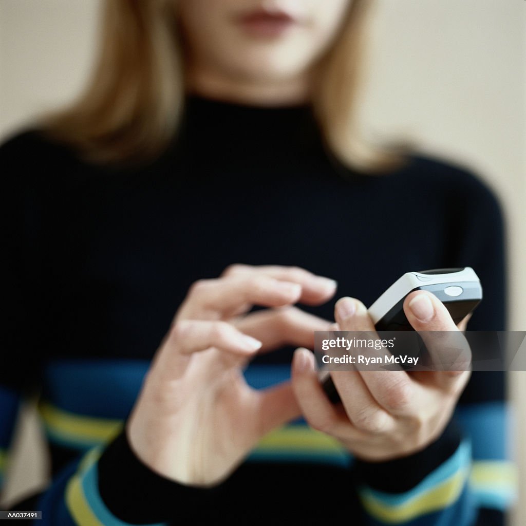 Young Woman Dialing Mobile Phone