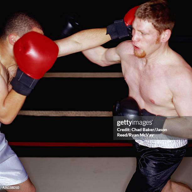 boxers fighting in a boxing ring - amateur boxer stock pictures, royalty-free photos & images