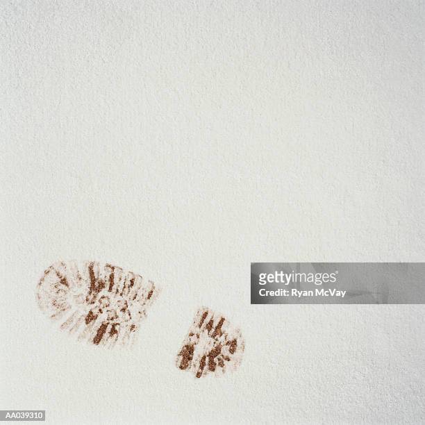 muddy footprint of boot in snow, elevated view - mud footprint stock pictures, royalty-free photos & images