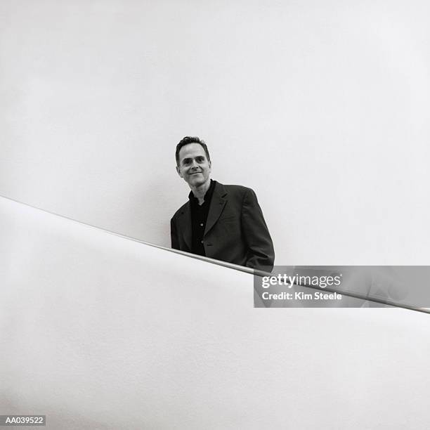 man on escalator, portrait (b&w) - artist yinka shonibare creates a giant maze to cover entire floor of gallery stockfoto's en -beelden