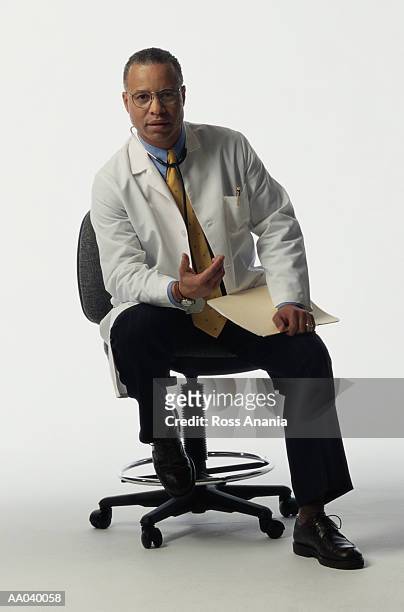 doctor with medical chart - doctor sitting stock pictures, royalty-free photos & images