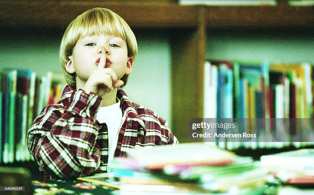 Portrait of a Boy Reading in a Library