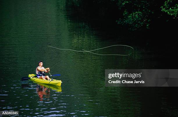 man in kayak, fly fishing on river - jarvis summers stock pictures, royalty-free photos & images