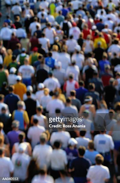 people running in marathon, rear view, elevated view (defocused) - marathon fotografías e imágenes de stock