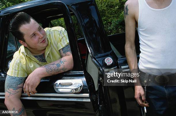 two young men smoking, one sitting in truck - 50s rockabilly men stock pictures, royalty-free photos & images