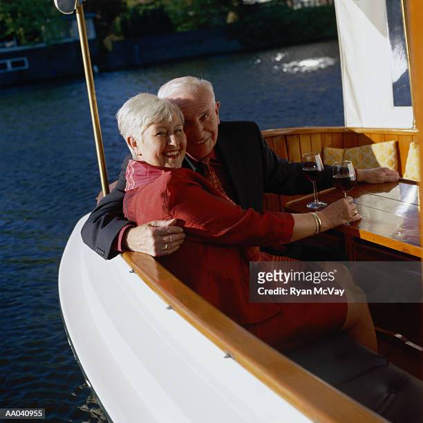 mature couple on boat, amsterdam - amsterdam mensen boot stockfoto's en -beelden