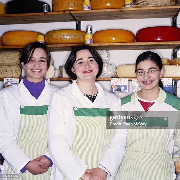 woman working in a delicatessen - cheese wheels shelves stock pictures, royalty-free photos & images