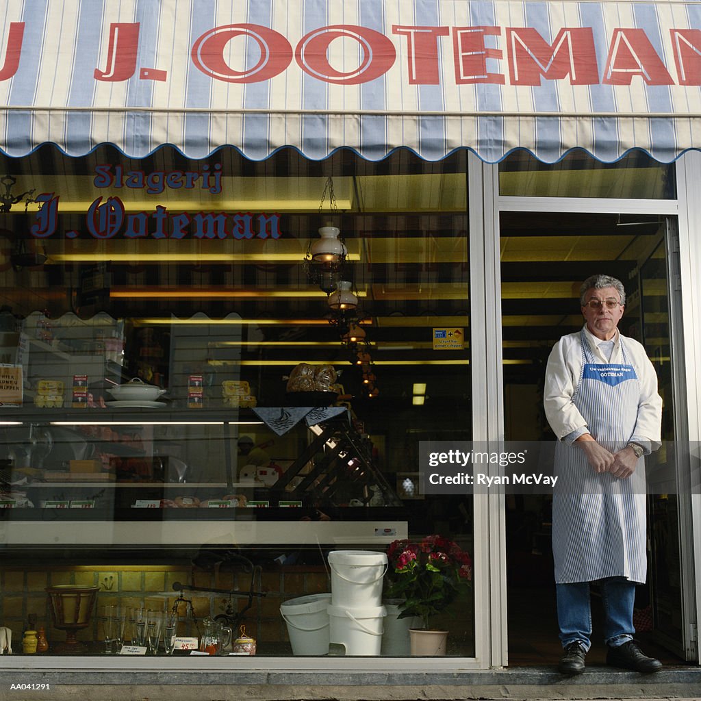Man Standing in Front of His Butcher Shop
