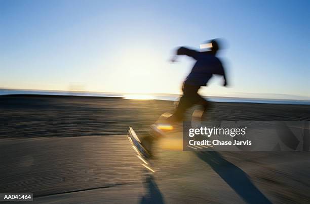 man skating on  beach, at sunset - jarvis summers stock pictures, royalty-free photos & images