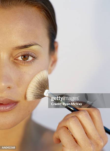 young woman applying make-up - blusher brush stock pictures, royalty-free photos & images