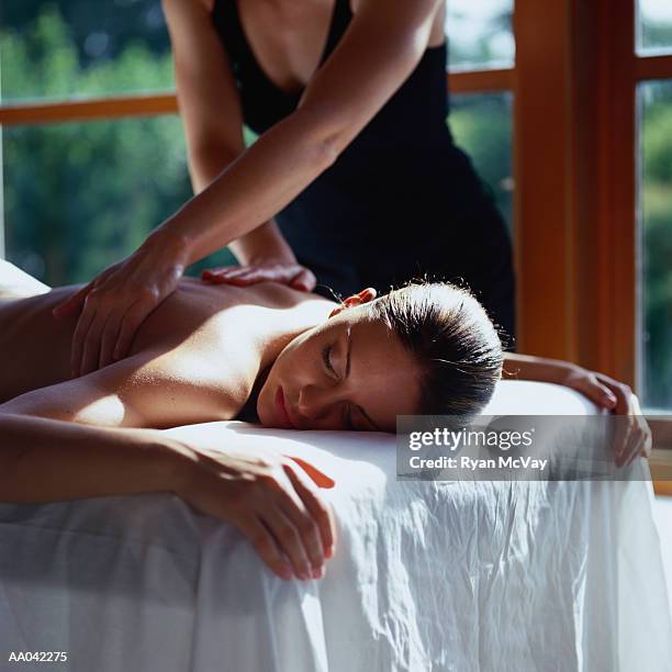 woman getting a message - women massage stock-fotos und bilder