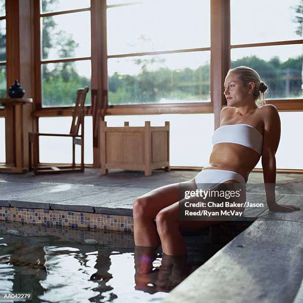 woman sitting near soaking pool - balneotherapy stock pictures, royalty-free photos & images