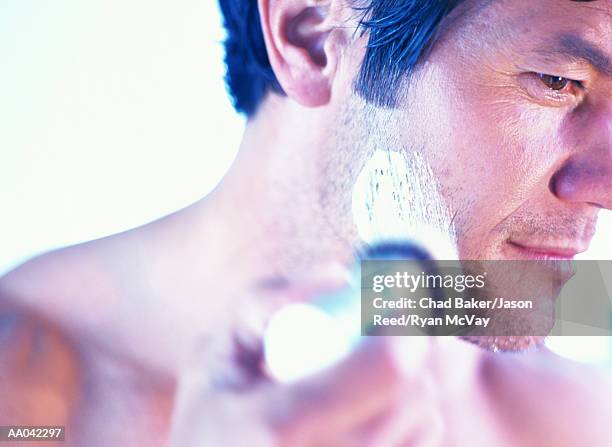 man lathering up to shave - pennello da barba foto e immagini stock