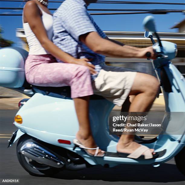 young couple on motor scooter, low section (blurred motion) - middle age imagens e fotografias de stock