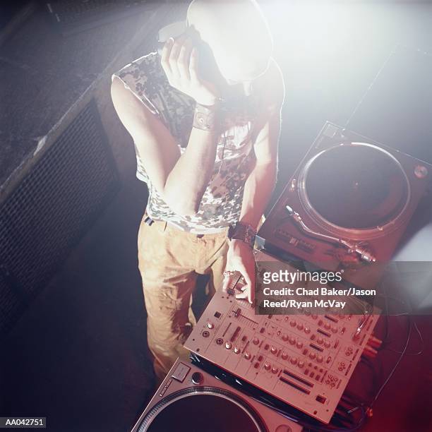 dj spinning records at nightclub, elevated view - dj de club fotografías e imágenes de stock