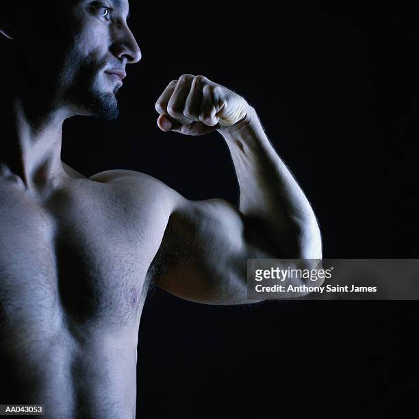 man flexing muscles (blue tone) - james hale stock pictures, royalty-free photos & images