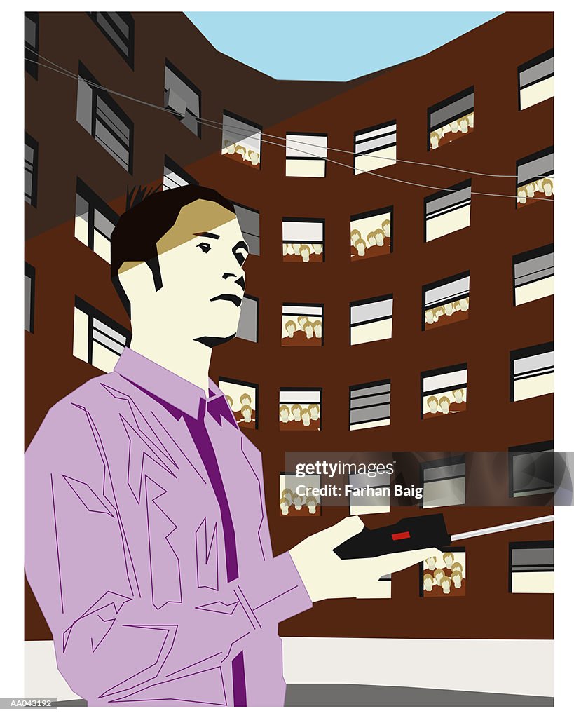 Man with mobil phone in front of building