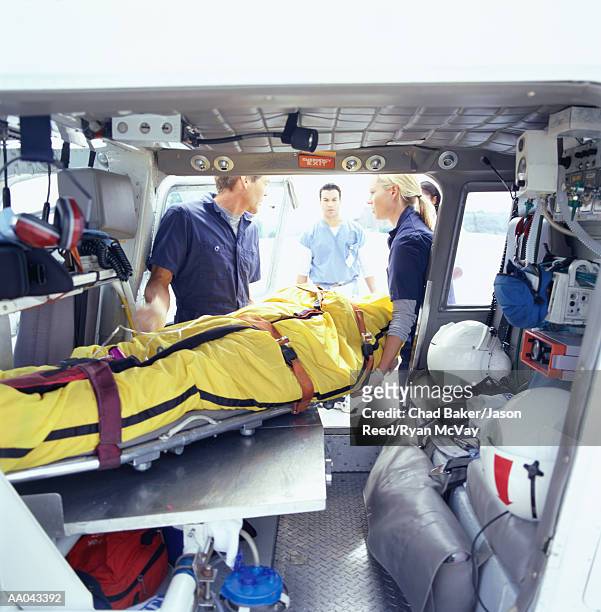 paramedics transporting patient in medevac - air ambulance stock pictures, royalty-free photos & images