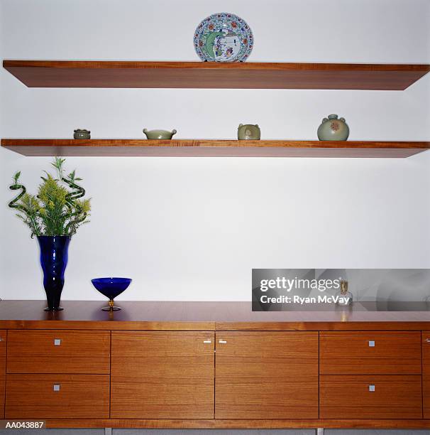 dresser and shelves covered with knick knacks - knick stock pictures, royalty-free photos & images