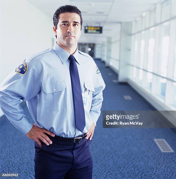 airport security guard standing with hands on hips, portrait - security guard stock pictures, royalty-free photos & images