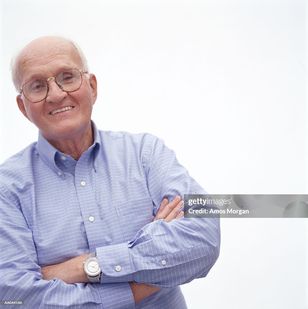 Senior man with arms crossed, portrait