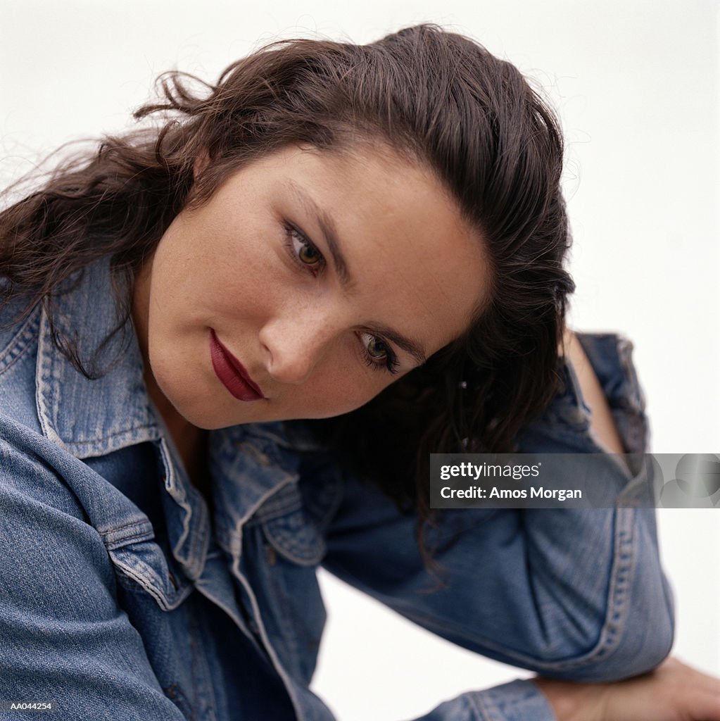 Young woman resting head on hand