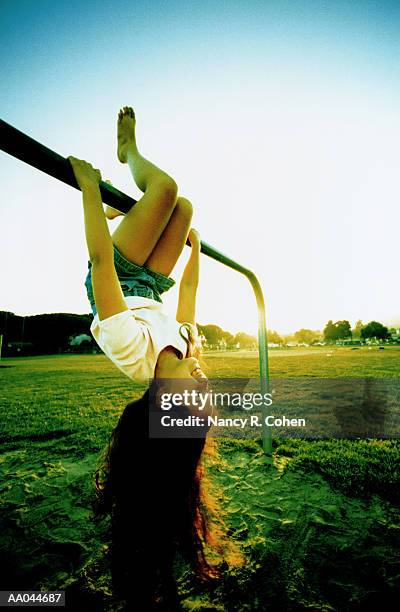 girl swinging on jungle gym - jungle gym ストックフォトと画像