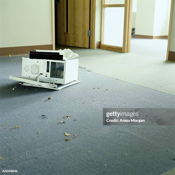 broken computer tower sitting on floor of empty office - computer tower stock pictures, royalty-free photos & images