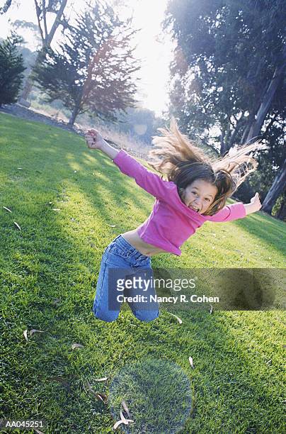 girl (7-9) jumping - nancy green stock-fotos und bilder