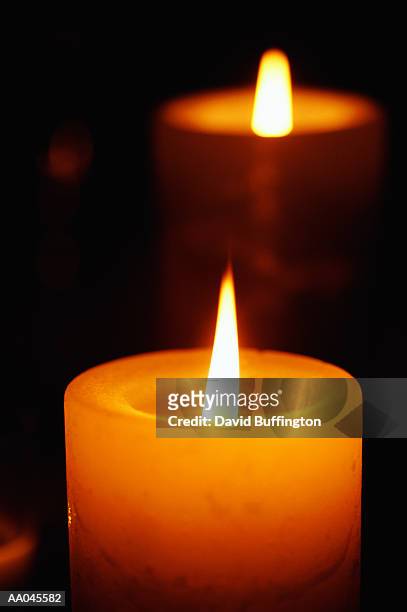 two illuminated candles - votive candle stock pictures, royalty-free photos & images