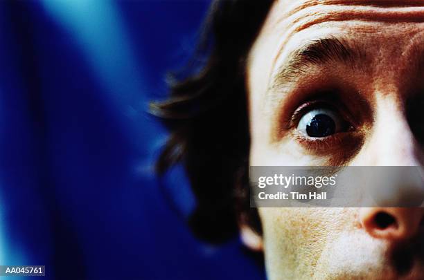 man with eye wide open - cross processed stock pictures, royalty-free photos & images