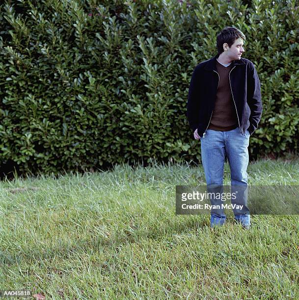 young man standing on the grass - 8897 stock pictures, royalty-free photos & images