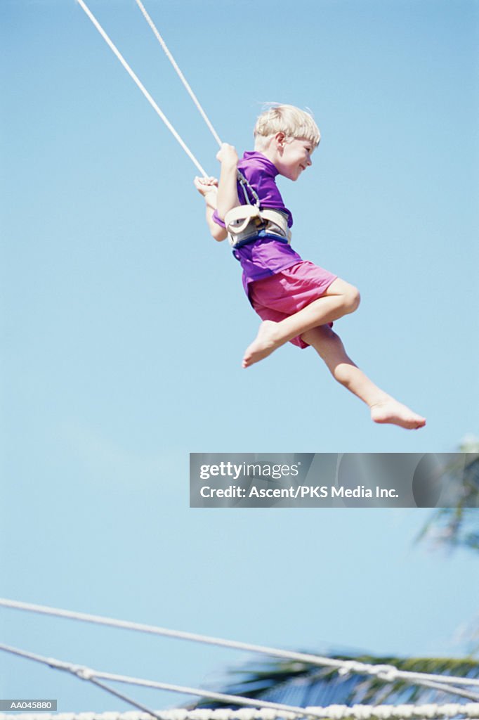 Young Boy Swinging on Trapeze