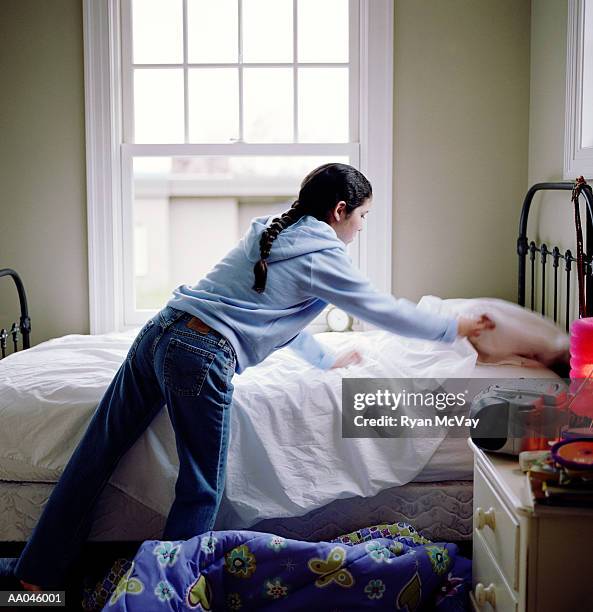 girl (10-12) making bed, rear view - girl 10 12 stock pictures, royalty-free photos & images