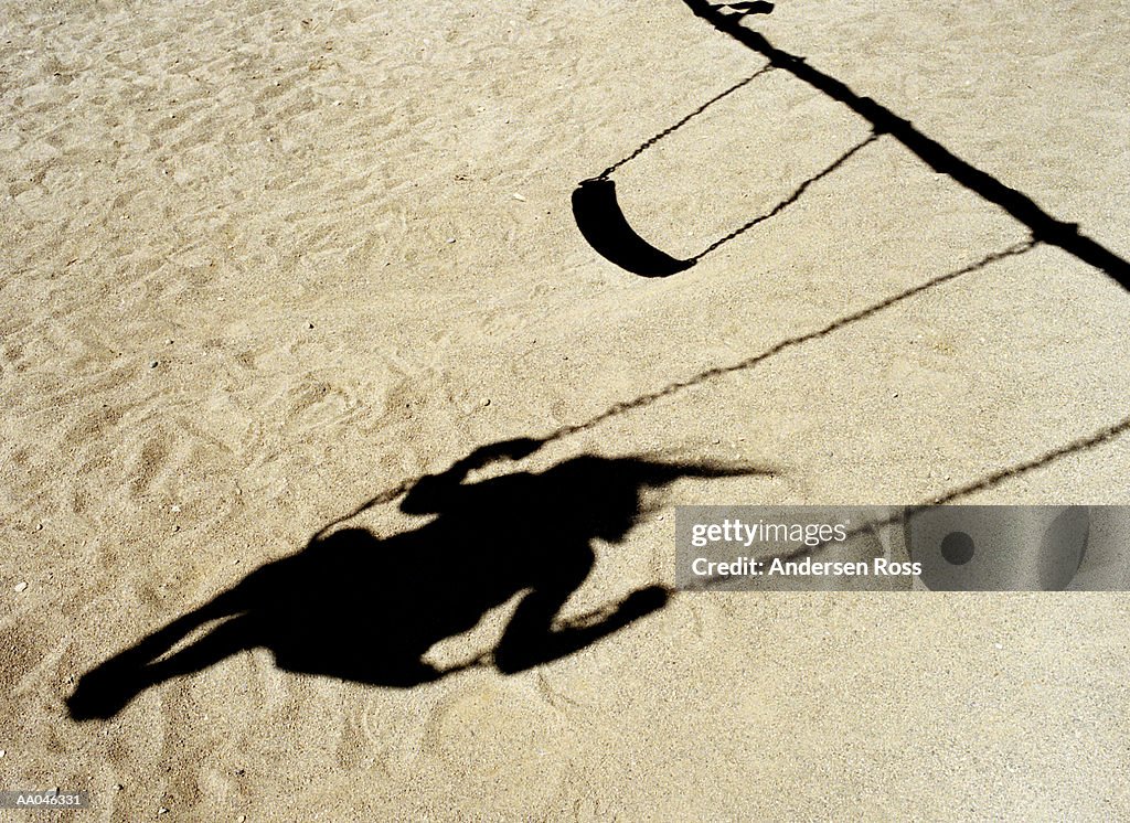 Shadow of girl on swing