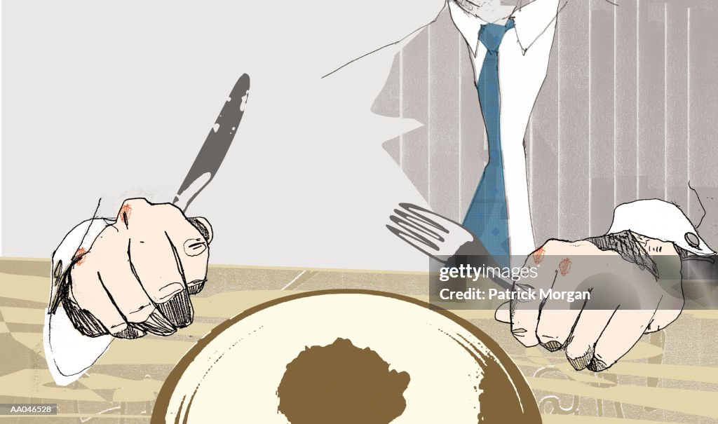 Man holding fork and knife above plate, close-up