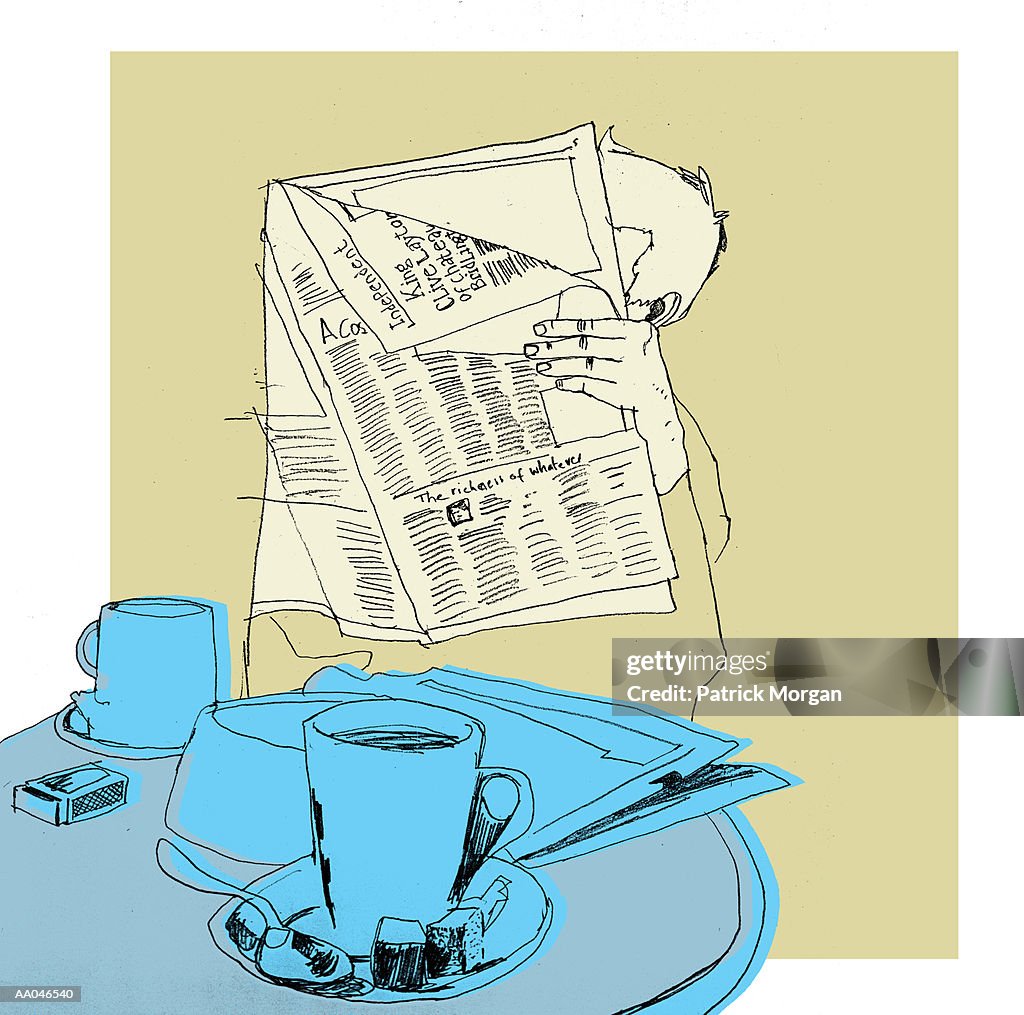 Man reading newspaper over breakfast