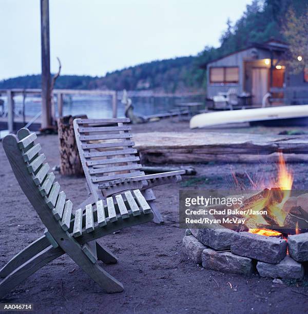 deck chairs beside campfire on beach - baker beach stock pictures, royalty-free photos & images