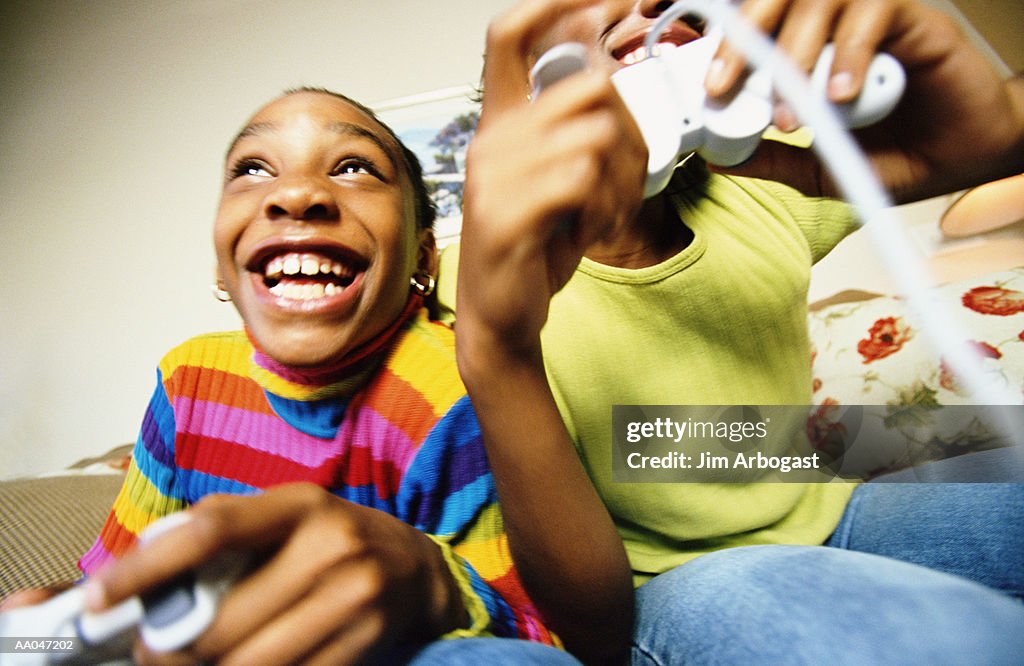 Two girls (8-15) playing video games