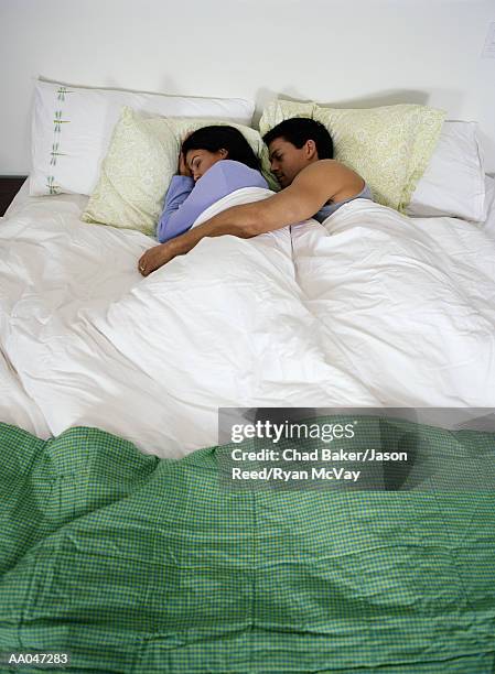 couple in bed, spooning - reed bed stock pictures, royalty-free photos & images