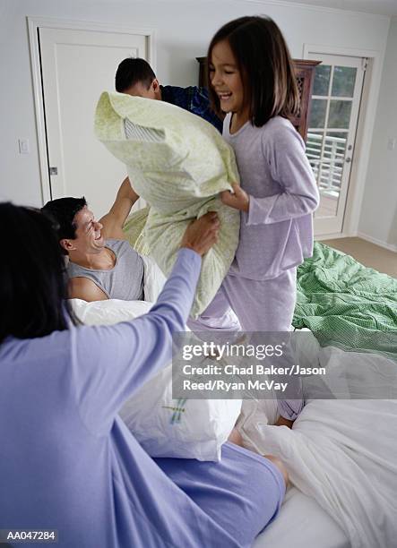 parents having pillow fight with son and daughter (6-8) - father and child and pillow fight stock pictures, royalty-free photos & images