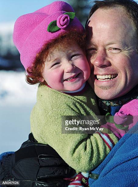 portrait of father and 3-year-old daughter hugging - 39 year old stock-fotos und bilder