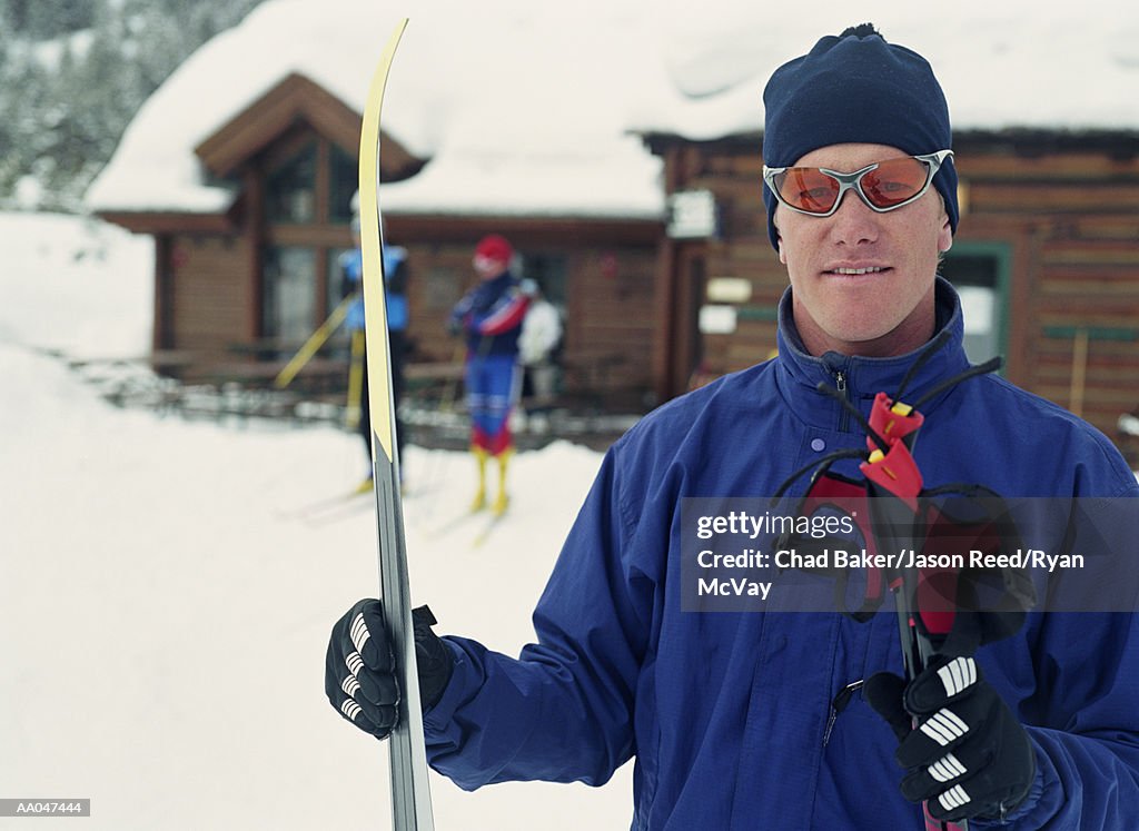 Portrait of Man with Skis, Outside of Ski Lodge