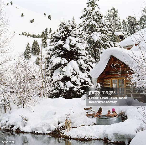 three young adults in outdoor hot tub surrounded by snow - three men in a tub stock pictures, royalty-free photos & images
