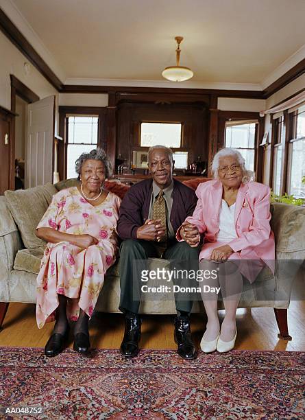 mature man holding hands with two elderly women, portrait - donna elegante stock-fotos und bilder