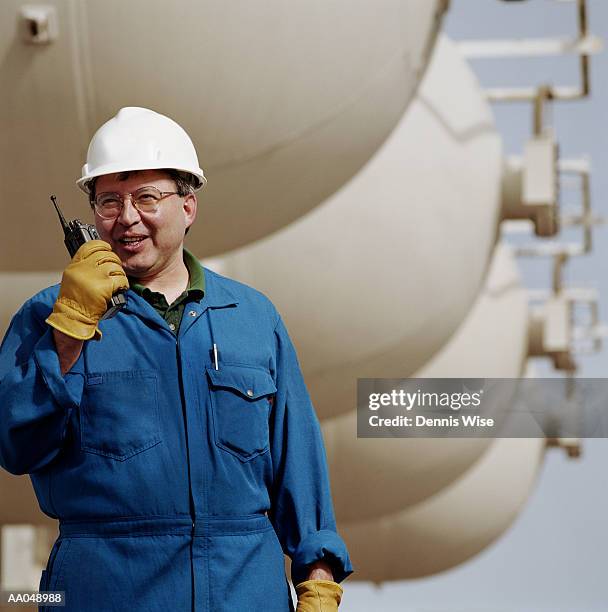 man wearing hard hat, using walkie talkie at oil refinery - anacortes stock pictures, royalty-free photos & images