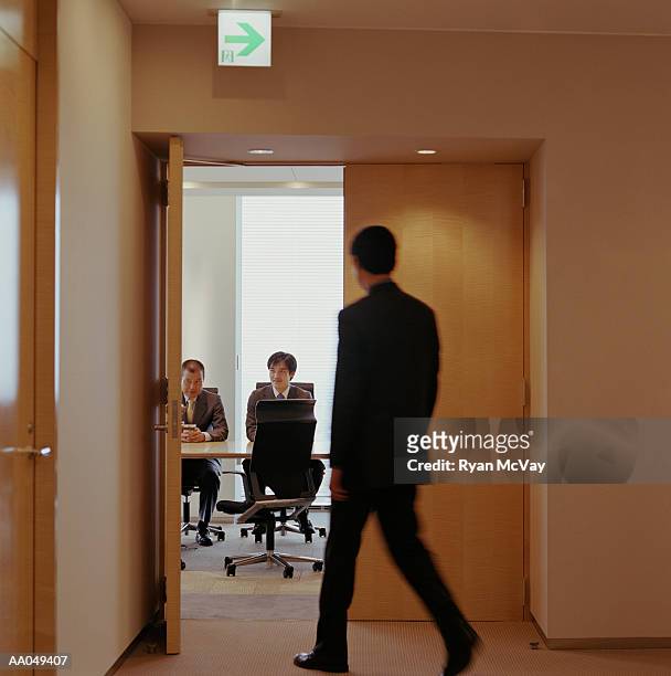 businessman entering conference room meeting (blurred motion) - japanese exit sign stock pictures, royalty-free photos & images
